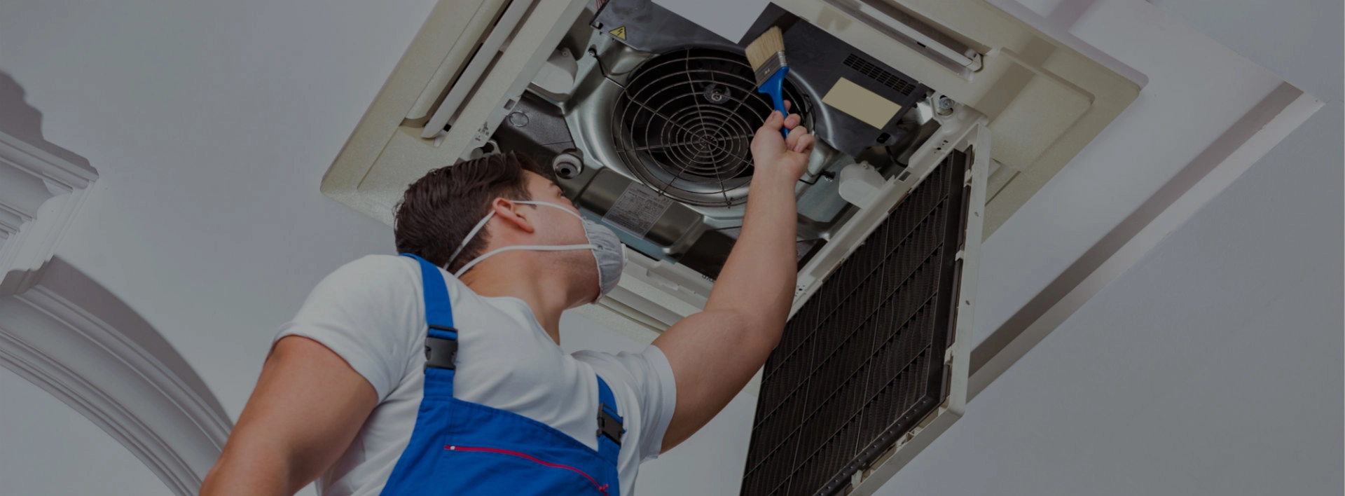 technician  servicing ducted AC